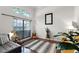 A sunlit living room boasts a large window, modern decor, hardwood floors, and a comfortable seating area, perfect for relaxation at 806 Spring Island Way, Orlando, FL 32828