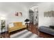 A cozy living room features a stylish yellow couch, an area rug, and hardwood floors that complement the bright, open space at 806 Spring Island Way, Orlando, FL 32828