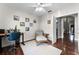 Inviting office features hardwood floors, a ceiling fan, and well-lit workspace with a comfy arm chair at 806 Spring Island Way, Orlando, FL 32828