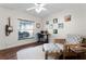 Bright office with hardwood floors, a ceiling fan, and a cozy sitting area next to a window at 806 Spring Island Way, Orlando, FL 32828