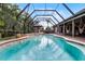 Relaxing screened in pool with outdoor seating and lounge furniture perfect for entertaining at 806 Spring Island Way, Orlando, FL 32828