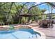 Enjoy a screened pool with a spa, lounge chairs and dining table and chairs at 806 Spring Island Way, Orlando, FL 32828