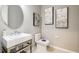 Modern bathroom featuring a sleek vanity with a square sink, chrome fixtures, and contemporary wall art at 862 Junonia Blvd, New Smyrna Beach, FL 32168