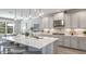 Modern kitchen with a large center island, stylish pendant lighting, stainless steel appliances, and ample cabinet space at 862 Junonia Blvd, New Smyrna Beach, FL 32168