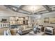 Open-concept living room with stylish furnishings, modern lighting, and a view into the kitchen at 862 Junonia Blvd, New Smyrna Beach, FL 32168