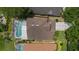 Overhead shot of a home featuring a screened-in pool, complemented by well-maintained landscaping at 985 N Lake Claire Cir, Oviedo, FL 32765