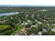 Aerial view of homes surrounded by lush greenery and a lake in a desirable neighborhood at 985 N Lake Claire Cir, Oviedo, FL 32765