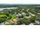 Panoramic aerial view of a lush, green community with a scenic lake and mature trees at 985 N Lake Claire Cir, Oviedo, FL 32765