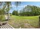 Picturesque backyard with a bench, mature trees, and lake views, perfect for relaxation and enjoying nature at 985 N Lake Claire Cir, Oviedo, FL 32765