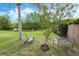 Serene backyard featuring seating, mature trees, and lake views creating a relaxing outdoor oasis at 985 N Lake Claire Cir, Oviedo, FL 32765