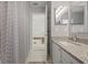 Bright bathroom featuring a gray chevron shower curtain and granite countertop vanity at 985 N Lake Claire Cir, Oviedo, FL 32765
