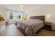 Sunlit bedroom with wood floors and light neutral walls at 985 N Lake Claire Cir, Oviedo, FL 32765