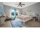 Comfortable bedroom with a desk, chair, and natural light from a large window at 985 N Lake Claire Cir, Oviedo, FL 32765