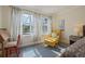 Comfortable bedroom with stylish yellow chair and natural lighting at 985 N Lake Claire Cir, Oviedo, FL 32765