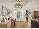 Bright foyer with a high ceiling, decorative white door, wood floors, and views into the living room at 985 N Lake Claire Cir, Oviedo, FL 32765