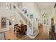 Bright foyer with hardwood floors, white staircase, and elegant decor at 985 N Lake Claire Cir, Oviedo, FL 32765