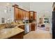 Open-concept kitchen featuring granite countertops, stainless steel appliances, and views into the main living spaces at 985 N Lake Claire Cir, Oviedo, FL 32765