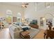 Bright living room with tall ceilings, a ceiling fan, and views of the refreshing pool area at 985 N Lake Claire Cir, Oviedo, FL 32765