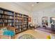 Open living area with built-in bookshelves, stylish seating, and seamless flow to adjacent living spaces at 985 N Lake Claire Cir, Oviedo, FL 32765