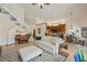Open-concept living room with hardwood floors, soaring ceilings, and seamless flow to the adjacent kitchen and dining area at 985 N Lake Claire Cir, Oviedo, FL 32765
