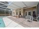 Spacious lanai with both seating and dining areas adjacent to the refreshing pool at 985 N Lake Claire Cir, Oviedo, FL 32765