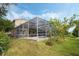 Backyard view of the screened-in pool and patio area, seamlessly blending indoor and outdoor living spaces at 985 N Lake Claire Cir, Oviedo, FL 32765