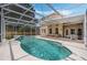 Inviting screened-in pool with clear blue water and a spacious patio for outdoor lounging and entertaining at 985 N Lake Claire Cir, Oviedo, FL 32765