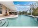 Beautiful in-ground pool and spa with a screened enclosure and outdoor living space at 985 N Lake Claire Cir, Oviedo, FL 32765