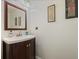 Charming powder room with a dark wood vanity and decorative wall art at 985 N Lake Claire Cir, Oviedo, FL 32765