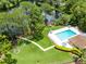 Overhead view of the community pool, tennis courts, lake, and beautifully landscaped surroundings at 102 Sand Pine Cir, Sanford, FL 32773
