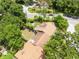 Overhead view of the home's backyard featuring a fire pit, privacy fence, and mature trees providing shade at 102 Sand Pine Cir, Sanford, FL 32773