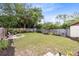 Spacious backyard featuring a fire pit, seating area, lush lawn, and new landscaping at 102 Sand Pine Cir, Sanford, FL 32773