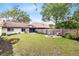 Large backyard with fire pit area, mature trees, and a well-kept lawn, perfect for outdoor activities at 102 Sand Pine Cir, Sanford, FL 32773