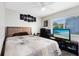 Well-lit bedroom featuring a mounted television, workstation, and a cozy queen-size bed at 102 Sand Pine Cir, Sanford, FL 32773