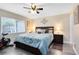 Calming bedroom featuring a queen-size bed, ceiling fan, and a window providing natural light at 102 Sand Pine Cir, Sanford, FL 32773