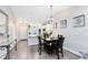 Dining area showcasing an open layout, modern lighting and wood-look flooring at 102 Sand Pine Cir, Sanford, FL 32773