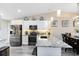 Bright kitchen featuring white cabinets, granite countertops, and stainless steel appliances at 102 Sand Pine Cir, Sanford, FL 32773