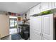 Functional laundry room with modern appliances, ample storage, and backyard access at 102 Sand Pine Cir, Sanford, FL 32773