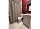 Compact bathroom featuring marble tiled floors, a modern vanity and a black geometric shower curtain at 112 Avocado Ave, Sanford, FL 32771