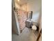 Clean bathroom featuring tiled shower with colorful curtain, modern vanity and toilet at 112 Avocado Ave, Sanford, FL 32771