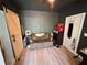 Cozy room featuring light hardwood floors, a loveseat, and a sliding barn door at 112 Avocado Ave, Sanford, FL 32771