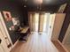 Bedroom featuring hardwood floors, a desk, and patio access through sliding glass doors at 112 Avocado Ave, Sanford, FL 32771