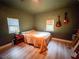 This bedroom features two guitars, two windows and a wood paneled floor at 112 Avocado Ave, Sanford, FL 32771