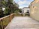 A wooden deck with a railing overlooks the yard and offers a relaxing outdoor space at 112 Avocado Ave, Sanford, FL 32771