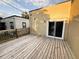 The wooden deck offers easy access via sliding glass doors and a charming wooden railing at 112 Avocado Ave, Sanford, FL 32771