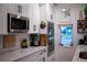 Well-lit kitchen with white cabinetry, stainless steel appliances, and sleek countertops at 112 Avocado Ave, Sanford, FL 32771