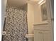 Cozy bathroom with marble floors, a shower with a patterned curtain, and a white vanity with storage at 13546 Summerton Dr, Orlando, FL 32824