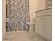 Clean bathroom featuring white marble floors, a stylish shower curtain, and a modern white vanity with ample storage at 13546 Summerton Dr, Orlando, FL 32824