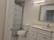 Updated bathroom with a modern vanity, a shower with a patterned curtain, and marble flooring at 13546 Summerton Dr, Orlando, FL 32824