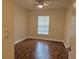 This bedroom offers wood flooring and a lighted ceiling fan at 13546 Summerton Dr, Orlando, FL 32824